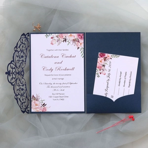 Detail view of navy laser cut wedding invitation set with floral card and RSVP on mesh
