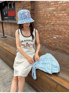 Chic blue plaid tote bag styled with a matching hat and sleeveless summer dress