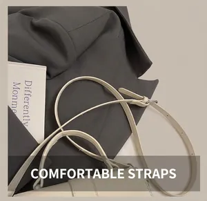 Close-up of the adjustable shoulder strap and silver hardware on a cream leather bag