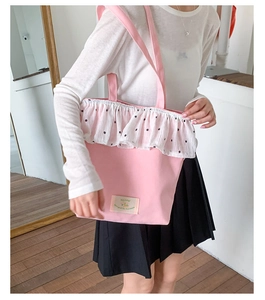 Detail of pink canvas tote bag with white floral lace trim and Happy everyday patch