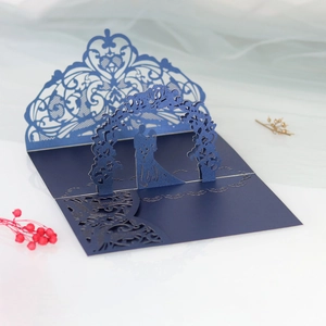 Macro view of blue laser cut 3D pop-up wedding card with bride and groom silhouette