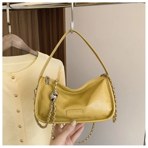 Detail of ginger hobo bag with C&HEKA leather label and elegant silver chain strap