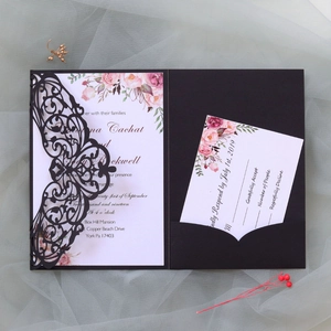 Detail of dark red laser-cut invitation with floral card and RSVP on mesh fabric