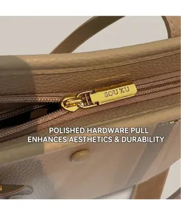 Detailed macro view of high-quality golden metal zipper head on beige leather handbag