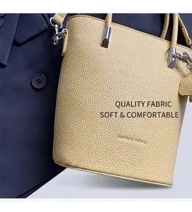 Close-up of yellow bucket bag showing lychee pattern leather and silver hardware details
