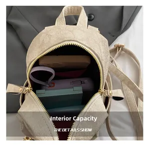 Internal view of beige textured mini backpack showing phone and power bank storage