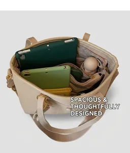 Detailed interior of beige lychee leather tote bag showing large storage space and pockets