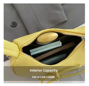 Macro view of the internal capacity showing phone and makeup inside the yellow bag
