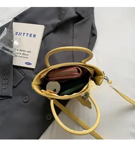 Interior view of yellow bucket bag showing storage space for wallet and phone