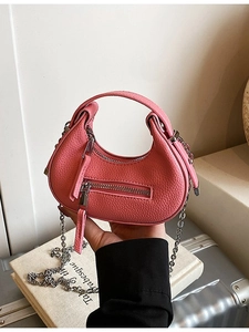 Pink pebbled leather half-moon handbag with gold chain strap and metal zipper detail