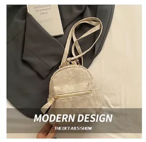 Detailed close-up of beige corduroy backpack fabric texture and gold zipper hardware