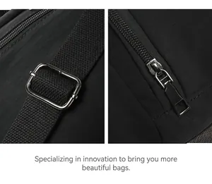 Macro detail of black nylon backpack featuring premium metal buckles and smooth zipper closure