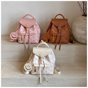 Detailed close-up of three fashion mini backpacks in pink, brown, and white with bear prints