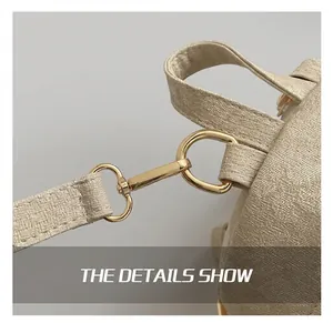 Close-up of beige woven canvas texture and premium golden metal hook connector details