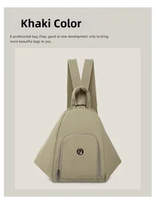 Detailed close-up of a khaki nylon backpack showing the unique triangular design and metal logo