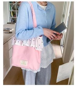 Close-up of pink tote bag showing ruffle trim details and lifestyle shoulder carry