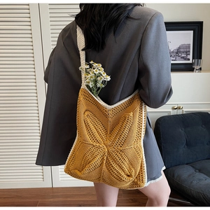 Detail of yellow crochet tote bag with star pattern and thick cotton shoulder strap