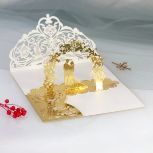 Detailed laser-cut 3D pop-up wedding invitation featuring gold floral arch and bride silhouette