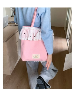 Pink canvas tote bag with white floral lace trim and shoulder strap for daily commuting