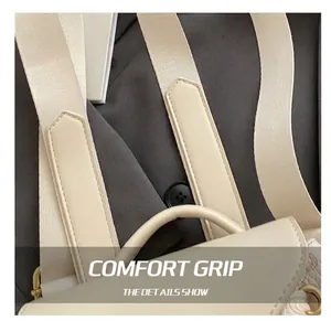 Detail of wide woven strap and leather reinforced handles on a cream travel backpack