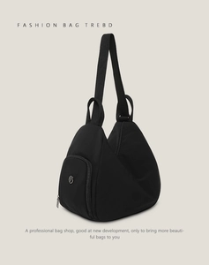 Close-up of black nylon Hobo bag with adjustable strap and metallic logo detail
