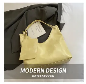 Detail view of bright yellow litchi grain tote bag with matching zipper pouch and strap