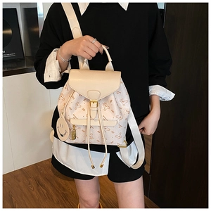 Cream faux leather backpack featuring brown bear prints and a smiley face charm detail