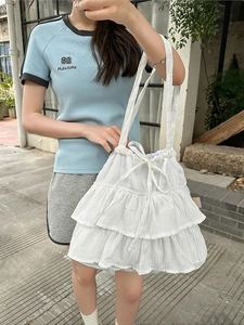 White minimalist ruffled tote bag with drawstring bow and elegant three-tier cake design
