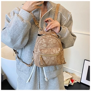 Close-up of brown floral mini backpack featuring double zippers and adjustable straps