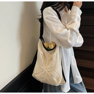 Crochet shoulder bag with star pattern hollow knit and black contrast trim on model