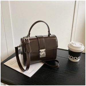 Detail of minimalist dark coffee square crossbody bag with vintage silver buckle