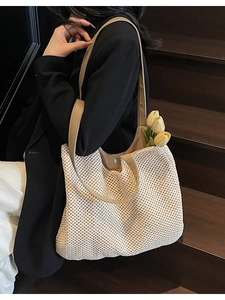 Minimalist woven tote bag with brown leather straps and beige crochet texture for beach travel