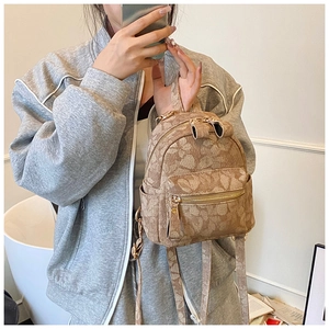 Detail view of mini floral backpack with gold zippers and adjustable shoulder straps