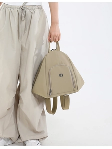 Detailed side view of khaki triangular backpack showing durable zipper and premium fabric texture