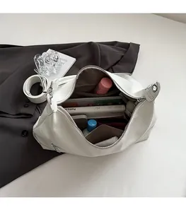 Interior view of white leather tote bag showing spacious capacity for books and water bottle