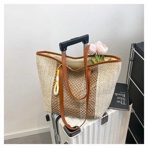 Detail view of woven beach tote showing large capacity and contrast leather handles