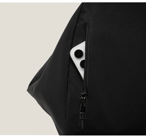 Detail view of a black backpack featuring a side vertical zipper pocket with a smartphone