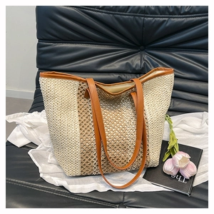 Close-up of the textured woven straw fabric and contrast brown PU leather shoulder straps