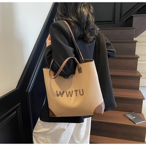Detail of large tote bag with contrast stitching and embossed WWTU lettering