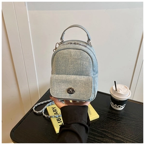 Mini light blue denim backpack with silver hardware and rotating buckle closure