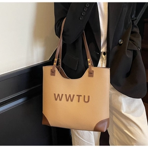 Detailed view of the large capacity tote bag with texture leather and logo embroidery