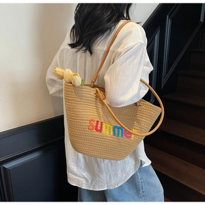 Detailed texture of handwoven tote bag featuring colorful Summer embroidery and leather strap