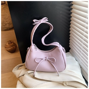 Detailed view of lavender lychee texture crescent bag with decorative bow and silver zipper