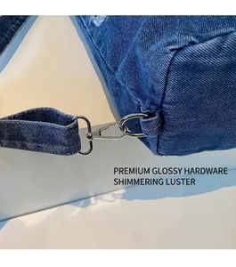Close-up of durable silver metal hook hardware on dark blue denim tote bag details