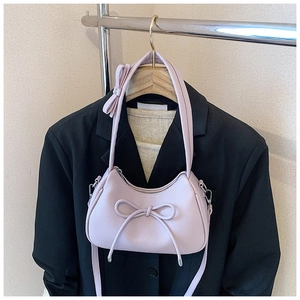 Detail of light purple bow hobo bag with litchi texture on a stylish blazer outfit