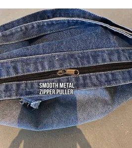 Detailed close-up of retro copper zipper and washed denim fabric with frayed edges