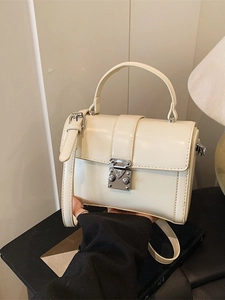 Classic cream-colored square shoulder bag with silver metal buckle and sleek leather finish