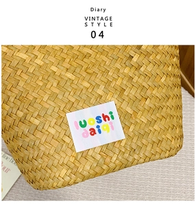 Macro detail of hand-woven straw bag texture featuring a colorful letter fabric patch