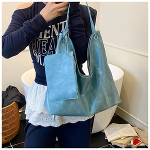 Large teal hobo tote bag in distressed leather texture with matching zipper pouch set