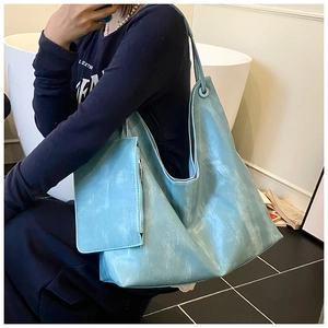Detailed side view of light blue tote bag set with matching small zipper pouch